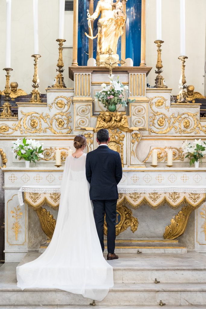 a man and woman standing in front of a altar