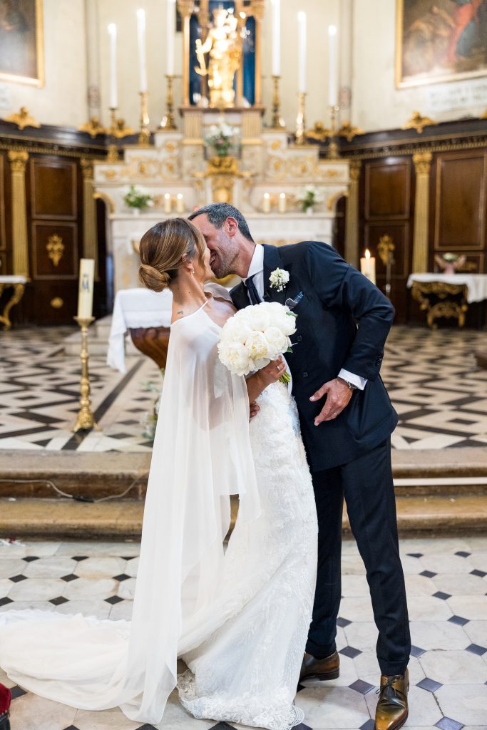a man and woman kissing in a church