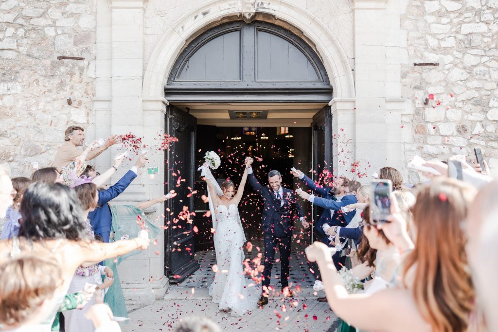 a bride and groom throwing confetti in the air