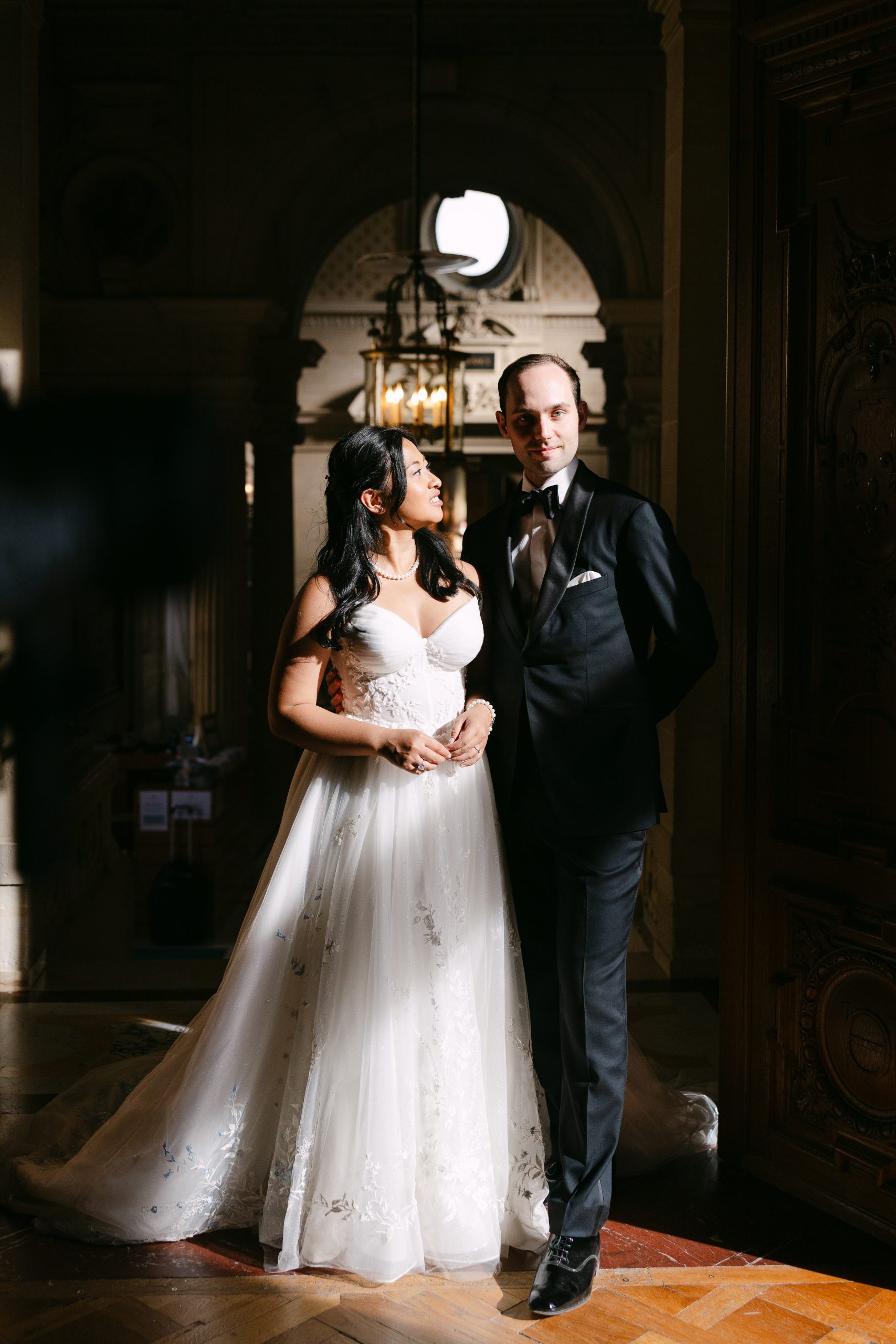 May and Thor sharing a romantic kiss at sunset during their wedding at Château de Chantilly, France.