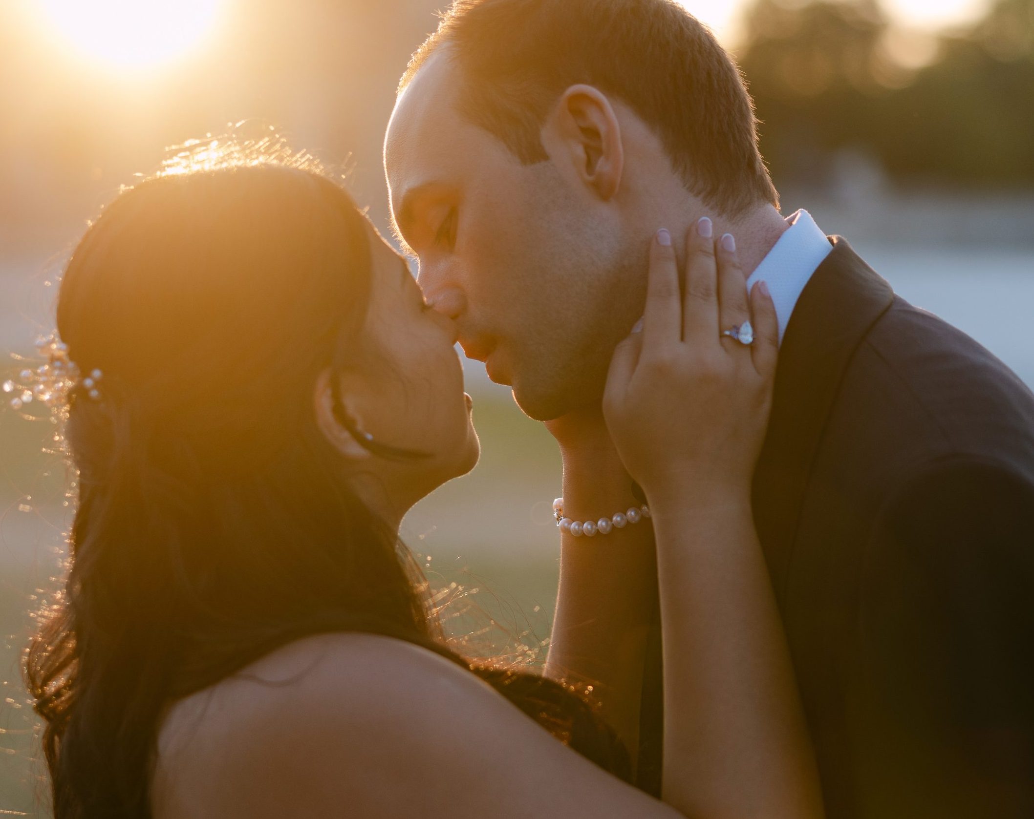 May and Thor sharing a romantic kiss at sunset during their wedding at Château de Chantilly, France.